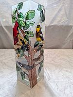 Front view of glass vase showing painted birds and tree