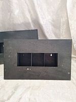 Rear view of one panel showing recessed triple-slot opening and keyhole hangers