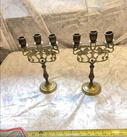 pair of brass three-arm lion menorahs full view