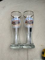 Front view of both beer glasses showing decals and gold rims