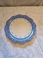 Front of scalloped blue-rimmed Pfaltzgraff plate