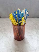 Picks stored in brown translucent container showing color assortment