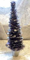 Full view of purple feather tree in silver pot