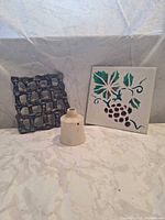 All three items together: pie funnel, grape tile, lattice trivet