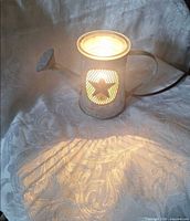 Warmer illuminated, projecting light pattern, shows function and star cut-out glow