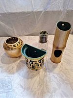 Group shot of four pieces: spherical vase, wall pocket planter, glass jar, brass-tone wall tube