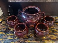 Front view of entire five-piece crock set