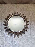 Front view of silver sunburst mirror