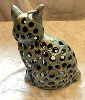 full view of cat-shaped perforated metal lantern