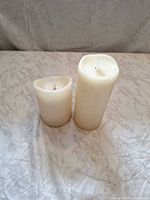 Front view of both candles standing upright