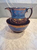 Pitcher resting inside matching bowl showing overall design and colours
