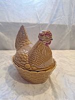 Front left view of ceramic hen covered dish
