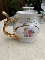 Side view showing floral decal, gold handle and trim