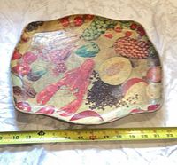Front of tray showing fruit and lobster design with tape measure indicating ~11 in width
