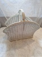 Side view showing curved wicker panels and handle