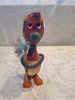 Front view of wooden kitchen witch figurine showing overall design and colours
