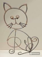 Full view of wrought iron cat holder showing overall design and condition