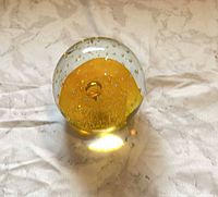 Front angled view showing amber core and bubble inclusions