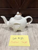 Full view of white ceramic elephant teapot with lid and trunk spout