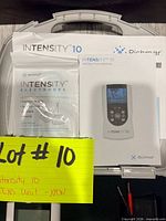 Open carry case showing TENS unit, electrodes pack and manual
