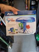 Retail box showing Aqueon 1.2 gal Betta Bowl Aquarium Kit with lid, divider, gravel, plant