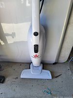 Front view of white Bissell Featherweight stick vacuum