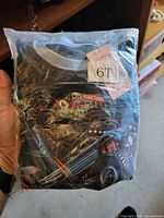 Packaged black T-shirt with monster truck graphic and 6T size tag visible