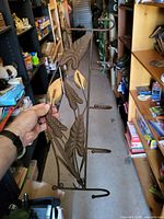 Front view of bronze metal wall hook hanger with five hooks and leaf motif