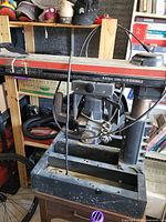 Overall view of Craftsman radial arm saw showing motor, sliding arm, fence rail, cord and metal base stand