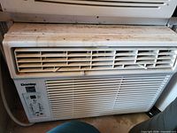 Front view of Danby window air conditioner showing louvers, control panel and heavy dirt