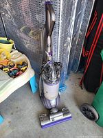 Full view of Dyson Ball Animal 2 upright vacuum with floor head and hose-wand