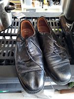 Top view of both shoes showing leather uppers, lacing, creasing