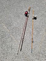 Both assembled rods laying on pavement showing full length, reels, grips and guides
