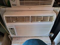 Front view of NOMA window air conditioner with vents and control panel visible