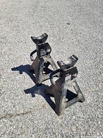 Front angled view of both jack stands showing ratcheting posts and bases