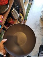 Top view showing brown non-stick interior and green handle