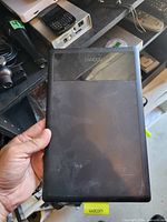 Front view of Wacom Bamboo graphics tablet showing branding, surface wear, size reference by hand