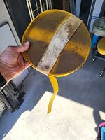 Coiled yellow nylon webbing with visible dirt on strap