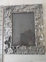 Front view showing vine relief design and glass opening