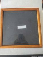 Front view of brown wood square picture frame with glass