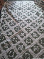 Entire quilt spread out showing full patchwork star pattern and king size coverage