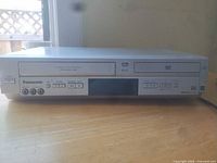 Front view showing VHS and DVD drives, controls and display