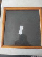 Front of square wooden frame with glass