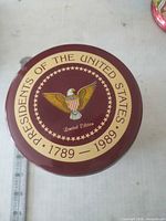 Top view showing eagle crest and commemorative text on lid