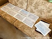 Set of prints spread out on sofa