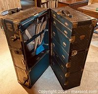 Trunk open showing drawers side and hanging section