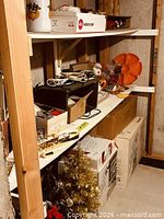 Overall view of shelves with Christmas and Halloween boxes and décor