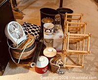 Group shot of all items arranged on floor, showing fan, baskets, jugs, racks, planters and smaller decor pieces
