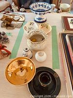 Overhead view showing all seven ceramic pieces within taped area