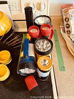 All eight flashlights grouped on stovetop